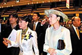 Judy Ongg leads Prince and Princess Mikasa in the hall with Yoshinobu Ishikawa, the director of the festival